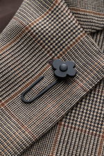 Close-up front angle of Lardini Blazer Beige/Black Checked showing Glencheck woven pattern, pure virgin wool, soft touch, slim fit, tailored two-button style, notched lapel with flower pin, classic breast pocket, patch hip pockets, unfinished sleeve ends,