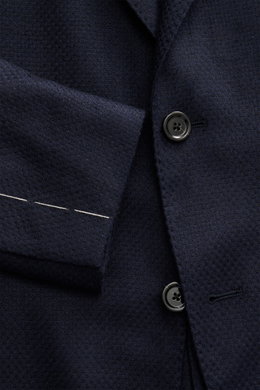 Close-up front view of Lardini Navy Blazer showing textured navy fabric, black buttons, and white stitching; mix of cashmere and silk, airy Panama weave, soft touch, Slim Fit, dropped lapel with flower pin, tailored two-button style, classic breast pocket