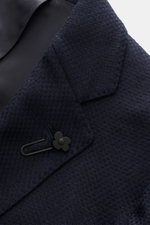 Close-up front view of the Lardini Navy Blazer showing dropped lapel with flower pin, tailored two-button style, mix of cashmere and silk, airy Panama weave, soft touch, slim fit, classic breast pocket, patch hip pockets, unfinished sleeve cuffs, rear sid