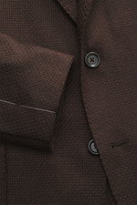 Close-up front view of Lardini Blazer dark brown showcasing mix of cashmere and silk, airy Panama weave, soft touch, slim fit, dropped lapel with flower pin, tailored two-button style, classic breast pocket, patch hip pockets, unfinished sleeve cuffs, rea