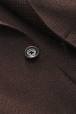 Close-up front view of Lardini Blazer dark brown showcasing a button on airy Panama weave fabric, soft touch, mix of cashmere and silk, Slim Fit, dropped lapel with flower pin, tailored two-button style, classic breast pocket, patch hip pockets, unfinishe