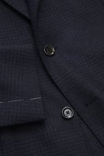 Close-up front view of Lardini Blazer navy/black checkered showing buttons, notched lapel, and fabric texture with subtle tonal Glencheck, mix of wool and cashmere, soft touch, airy woven structure, Slim Fit, tailored two-button style, classic breast pock
