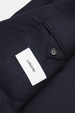 Close-up view of the Lardini Blazer navy/black checkered sleeve showing soft wool-cashmere mix, soft touch, airy woven structure, subtle tonal Glencheck, slim fit, tailored two-button style, notched lapel with flower pin, classic breast pocket, hip pocket