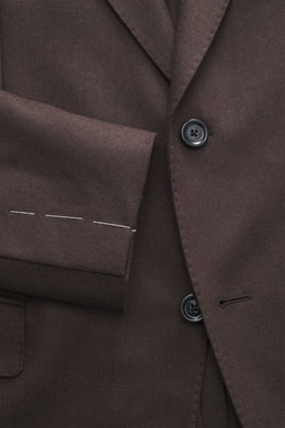 Close-up front view of Lardini Brown Jersey Blazer showcasing slim fit, two-button tailored style, notched lapel with flower pin, classic breast pocket, hip flap pockets, unfinished sleeve cuffs, rear vents, unconstructed design, made of soft pure virgin 