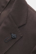 Close-up front view of Lardini Brown Jersey Blazer showcasing pure virgin wool texture, soft touch, slim fit, tailored two-button style, notched lapel with flower pin, classic breast pocket, hip pockets with flap, unfinished sleeve cuffs, rear side vents,