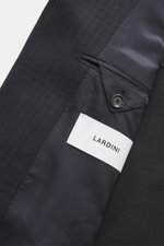 Close-up view of the inside and fabric of the Lardini Navy patterned blazer showing pure virgin wool, structured woven pattern, Slim Fit, notch lapel, double-breasted two-button style, classic breast pocket, hip pockets with flap, unfinished sleeve cuffs,