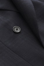 Close-up front view of Lardini Navy patterned blazer showing pure virgin wool with structured woven pattern, Slim Fit, notch lapel, double-breasted two-button style, classic breast pocket, hip pockets with flap, unfinished sleeve cuffs, rear side vents, h
