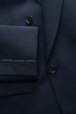 Close-up front view of Lardini Blazer navy, gabardine made of pure new wool with smooth feel, slim fit, notch lapel, double-breasted two-button style, classic breast pocket, hip pockets with flap, unfinished sleeve cuffs, rear side vents, half lined, and 