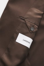 Close-up view of the Lardini Dark Brown Blazer's interior showing gabardine pure new wool fabric, smooth touch, slim fit, notched lapel, double-breasted two-button style, classic breast pocket, hip flap pockets, unfinished sleeve cuffs, rear side vents, h