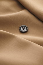 Close-up front view of Lardini Blazer light brown fabric showing a black button and smooth gabardine made of pure new wool with a slim fit, notch lapel, double-breasted two-button style, classic breast pocket, hip pockets with flap, unfinished sleeve cuff