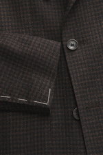 Close-up front side view of Tagliatore Blazer dark brown/black checkered showcasing double-breasted three-button style, peaked lapel, classic breast pocket, and soft virgin wool-silk blend with subtle houndstooth pattern, unfinished sleeve ends, and visib