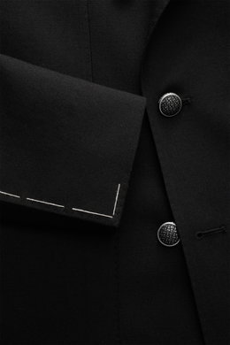 Close-up view of the Tagliatore Black Blazer’s black pure new wool fabric, showing detailed buttons, sleeve cuff, and textured weave.

Description: <p>The double-breasted blazer by TAGLIATORE made of pure new wool combines Italian tailoring craftsmanship 
