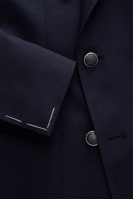 Close-up front view of the Tagliatore Blazer navy showing the textured pure virgin wool fabric, double-breasted three-button style with distinctive buttons, peak lapels, and unfinished sleeve ends. The blazer combines Italian tailoring with contemporary l