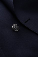 Close-up front-right view of the Tagliatore Blazer navy showing textured pure virgin wool fabric, metal patterned button, and lapel edge.

Description: 
<p>The double-breasted blazer by TAGLIATORE made of pure virgin wool combines Italian tailoring with c