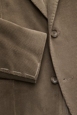 Close-up front view of Tagliatore Cord Blazer taupe in soft cotton-wool corduroy, slim fit with two buttons, notched lapel, classic breast pocket, patch hip pockets, unfinished sleeve cuffs, rear vents, unconstructed design, and brand pin.