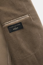 Close-up view of the Tagliatore Cord Blazer taupe showing the soft cotton-wool corduroy fabric, classic breast pocket, and brand label inside the blazer. The unconstructed design made from soft cord makes this blazer by TAGLIATORE an exclusive companion f