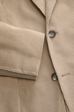 Close-up front view of the Tagliatore Cord Blazer beige showing soft cotton-wool corduroy, slim fit, two-button style, notched lapel, pin, breast and patch hip pockets, unfinished sleeve cuffs, and unconstructed design.
