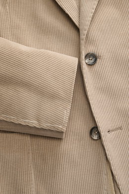 Close-up front view of the Tagliatore Cord Blazer beige showing soft cotton-wool corduroy, slim fit, two-button style, notched lapel, pin, breast and patch hip pockets, unfinished sleeve cuffs, and unconstructed design.