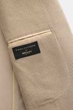 Close-up view of the beige Tagliatore Cord Blazer showing soft cotton-wool corduroy fabric, inner pocket, and brand label.

Description: <p>The unconstructed design made from soft cord makes this blazer by TAGLIATORE an exclusive companion for the office.