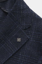 Close-up front angle of Tagliatore Blazer navy/black checked showing its Prince of Wales pattern, soft virgin wool and microfiber mix, slim fit, tailored two-button style, notched lapel with brand-typical pin, classic breast pocket, patch hip pockets, rea