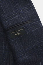Close-up view of the Tagliatore Blazer navy/black checked showing the Prince of Wales pattern mix of virgin wool and microfiber, soft feel, tailored two-button style with notched lapel, brand-typical pin, classic breast pocket, patch hip pockets, rear sid