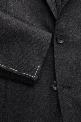 Close-up front view of Tagliatore Dark Grey Melange Blazer showing soft wool with cashmere, buttons, and tailored two-button style.

Description: <p>The unconstructed craftsmanship made from fine wool with cashmere makes this blazer by TAGLIATORE an exclu