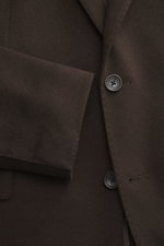 Close-up image taken from the front showing the Tagliatore Cashmere Blazer Dark Brown's button, notched lapel, and soft pure cashmere fabric. The unconstructed design features a slim fit, tailored two-button style, classic breast pocket, piped ticket pock