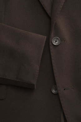 Close-up image taken from the front showing the Tagliatore Cashmere Blazer Dark Brown's button, notched lapel, and soft pure cashmere fabric. The unconstructed design features a slim fit, tailored two-button style, classic breast pocket, piped ticket pock