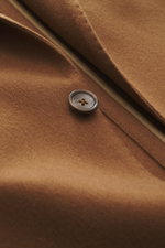 Close-up front view of Tagliatore Cashmere Blazer Brown showing soft pure cashmere fabric, button, and notched lapel.  
<p>The unconstructed design made from pure cashmere makes this lightweight blazer by TAGLIATORE an exclusive companion for the office a