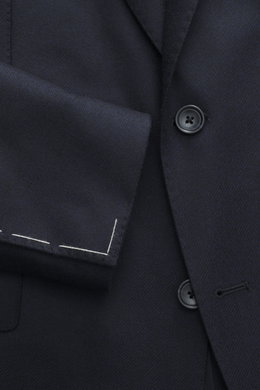 Close-up front view of Tagliatore Navy Blazer showing wool with cashmere content, soft touch, slim fit, tailored two-button style with notched lapel, brand-typical pin on lapel, classic breast pocket, patch hip pockets, unfinished sleeve cuffs, back side 
