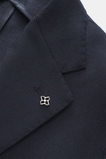 Close-up front angle of Tagliatore Navy Blazer showing wool with cashmere content, soft touch, slim fit, tailored two-button style, notched lapel with brand-typical pin, classic breast pocket, patch hip pockets, unfinished sleeve cuffs, back side vents, u