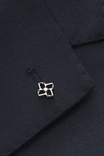Close-up front view of Tagliatore Navy Blazer showing wool with cashmere content, soft touch, slim fit, tailored two-button style, notched lapel with brand-typical pin, classic breast pocket, patch hip pockets, unfinished sleeve cuffs, back side vents, un