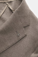 Close-up front view of the taupe Tagliatore Blazer showing wool with cashmere content, soft touch, slim fit, tailored two-button style, notched lapel with brand-typical pin, classic breast pocket, patch hip pockets, unfinished sleeve cuffs, back side vent