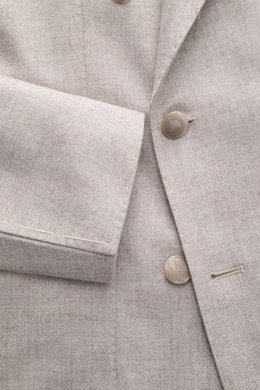 Close-up front view of the Tagliatore Taupe Melange Blazer showcasing its soft virgin wool-cashmere blend fabric, double-breasted three-button style, peaked lapel with signature pin, classic breast pocket, and unfinished sleeve cuffs. Italian tailoring at