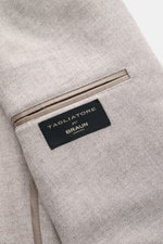 Close-up inside view of the Tagliatore Taupe Melange Blazer showing the label pocket and fabric texture, photographed from above. Italian tailoring at its most modern: The lightweight blazer from TAGLIATORE impresses with the finest virgin wool-cashmere b