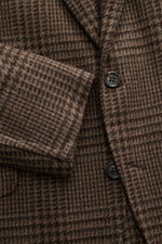 Close-up front angle of Brunello Cucinelli Blazer navy/black checkered showing virgin wool with cashmere content, soft touch, slim fit, tailored three-button style, notched lapel, classic breast pocket, hip pockets with flap, ticket pocket with flap, unfi