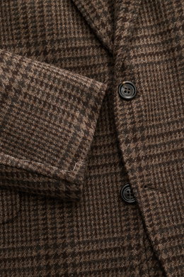 Close-up front angle of Brunello Cucinelli Blazer navy/black checkered showing virgin wool with cashmere content, soft touch, slim fit, tailored three-button style, notched lapel, classic breast pocket, hip pockets with flap, ticket pocket with flap, unfi
