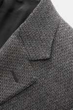 Close-up front angled view of Canali Blazer grey patterned made of pure wool with a distinctive woven pattern, soft touch, slim fit, tailored two-button style, notched lapel, classic breast pocket, hip pockets with flap, sleeve ends unfinished, rear side 