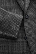Close-up front view of Canali Blazer Dark Grey/Grey Checked showing pure wool fabric with Prince-of-Wales pattern, soft touch, slim fit, tailored two-button style, notched lapel, classic breast pocket, hip pockets with flap, unfinished sleeve cuffs, rear 