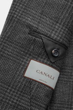Close-up view of the Canali Blazer Dark Grey/Grey Checked showing pure wool fabric with Prince-of-Wales pattern, soft touch, slim fit, tailored two-button style, notched lapel, classic breast pocket, hip pockets with flap, unfinished sleeve cuffs, rear si