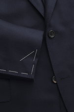 Close-up front angle of Canali Blazer navy showing wool with silk fabric in tonal woven pattern, soft touch, slim fit, tailored two-button style, notched lapel, classic breast pocket, hip pockets with flap, unfinished sleeve cuffs, rear side vents, uncons
