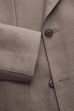 Luigi Bianchi Sakko taupe aus reiner Schurwolle, Nahaufnahme von Ärmel und Knopfleiste, zweireihiger Slim Fit mit Panama-Struktur.