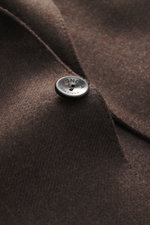 Close-up front angle of Agnona Cashmere Blazer dark brown melange showing pure cashmere fabric, very soft touch, slim fit, tailored two-button style, notched lapel, classic breast pocket, patch hip pockets, kissing buttons, rear side vents, unstructured d