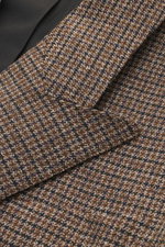 Ami Paris Blazer khaki/navy checkered close-up from front side showing mini houndstooth weave pattern, pure new wool, slim fit, double-breasted three-button style, peak lapel, hip pockets with flap, sleeve cuffs with buttons, rear side vents, soft lining 