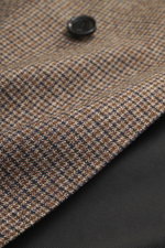 Ami Paris Blazer khaki/navy checkered close-up from above showing pure new wool fabric with mini houndstooth weave pattern and button detail. Slim fit, double-breasted three-button style, peak lapel, hip pockets with flap, sleeve cuffs with buttons, rear 
