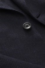 Close-up from above of the Zegna Blazer 'Couture' navy/black patterned showing button, buttonhole, and subtle herringbone texture.

Description:  
<p>A statement piece for the highest demands: The 'Couture' blazer by ZEGNA combines fine cashmere with silk