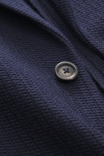Nahaufnahme des Circolo 1901 Strickblazers navy aus edlem Woll-Mix mit markantem Strick und Knopf, gesehen aus frontaler Perspektive.