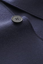Close-up front detail of Harris Wharf London Smart-casual jacket 'Nehru Jacket' anthracite melange showing button, blouson collar, and fine virgin wool texture from a side angle. 

<p>The stylish unconstructed smart-casual jacket 'Nehru Jacket' made of fi