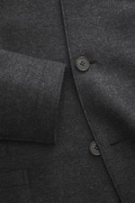 Harris Wharf London Smart-casual jacket 'Nehru Jacket' anthracite melange shown in close-up from top front angle, featuring pure virgin wool, soft feel, slim fit, raw-edged finish, fitted four-button style, blouson collar, patch hip pockets, unconstructed