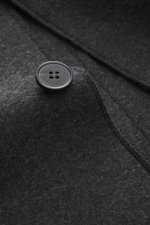 Harris Wharf London Smart-casual jacket 'Nehru Jacket' anthracite melange close-up of textured virgin wool fabric and four-hole button, angled view.